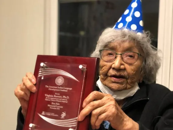 Virginia Beavert holds the Ken Hale Award plaque from AILDI