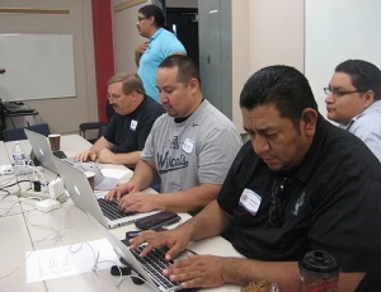 Three male typing using laptop