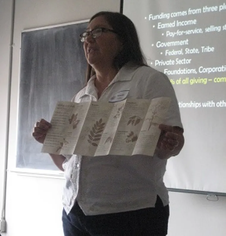 a lady presenting in front of the room