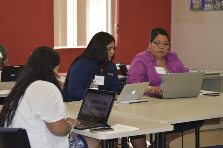 Three female using laptop