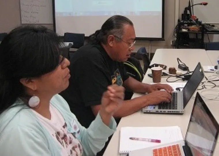 One male and one female using laptop