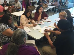 People working on handout activities around the table.