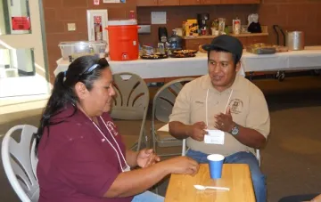 a woman and man talking around the table