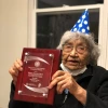 Virginia Beavert holds the Ken Hale Award plaque from AILDI